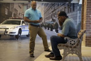 In this Wednesday, Sept. 2, 2015 photo, Officer Lamont Edwards talks to actor Nathan Purdee during a Crisis Intervention Training class at the New York Police Department Police Academy, in New York. A new training for New York City police is combining actors, the mentally ill and psychology experts to better prepare officers responding to people in the throes of a mental crisis. (AP Photo/Mary Altaffer)